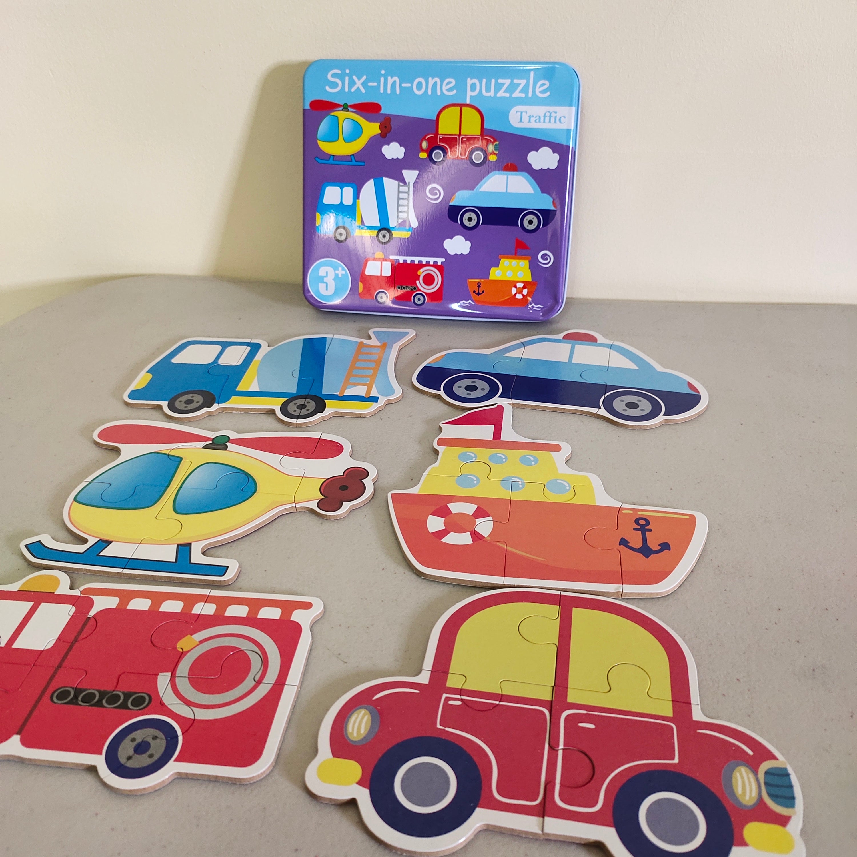 Fidtoy Casse-tête 6-en-1 avec numéros et boîte de rangement en métal sur le thème des transports pour enfants, ensemble de puzzles de reconnaissance des numéros sur le thème des transports, puzzle d'apprentissage évolutif pour les tout-petits de 2 à 6 ans