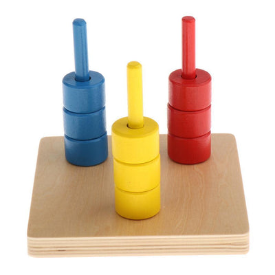 Discos de colores Montessori en tres espigas verticales